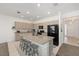 Modern kitchen featuring stainless steel appliances, granite countertops, and an island with seating for three at 7571 Sw 64Th Street Rd, Ocala, FL 34474
