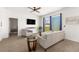 Cozy living room featuring a ceiling fan, comfortable seating, a large window, and modern decor at 7571 Sw 64Th Street Rd, Ocala, FL 34474