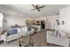 Open concept living room with ceiling fan, neutral tones, view of kitchen, and access to the dining area at 7571 Sw 64Th Street Rd, Ocala, FL 34474