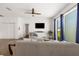 Bright living room with ceiling fan, comfortable seating, and access to an outdoor area at 7571 Sw 64Th Street Rd, Ocala, FL 34474