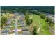 An aerial view features homes near a golf course and wooded areas at 96 Hickory Crse, Ocala, FL 34472