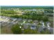 Community aerial showing neighborhood homes, green spaces, and a nearby lake at 96 Hickory Crse, Ocala, FL 34472