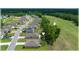 An aerial view of a golf course community featuring single Gathering homes and a lush green fairway, backing up to tree line at 96 Hickory Crse, Ocala, FL 34472