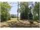 Serene backyard with lush greenery, offering a peaceful retreat at 96 Hickory Crse, Ocala, FL 34472