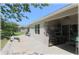 Backyard patio with outdoor kitchen, table, and view of the yard at 96 Hickory Crse, Ocala, FL 34472