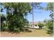 Spacious backyard with mature trees, offering privacy and shade at 96 Hickory Crse, Ocala, FL 34472