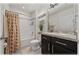 Well-lit bathroom featuring modern fixtures, stylish vanity, and a shower-tub combo with neutral curtain at 96 Hickory Crse, Ocala, FL 34472