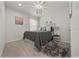 Stylish bedroom boasts a queen-sized bed with decorative pillows and a modern light fixture at 96 Hickory Crse, Ocala, FL 34472