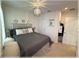 Bedroom features a queen bed, neutral carpet, and updated lighting fixtures at 96 Hickory Crse, Ocala, FL 34472