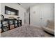 Bright bedroom features a plush rug, shelves, and a wall-mounted TV for comfort and entertainment at 96 Hickory Crse, Ocala, FL 34472