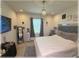 Bedroom with queen bed, TV, a modern dresser and a stylish light fixture at 96 Hickory Crse, Ocala, FL 34472