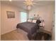 Comfortable bedroom with a queen bed, modern decor and stylish light fixture at 96 Hickory Crse, Ocala, FL 34472