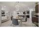 Open-concept dining room, kitchen and living room with modern decor and lighting at 96 Hickory Crse, Ocala, FL 34472