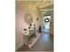 Elegant foyer with a mirrored console table and decorative mirror, enhanced by modern lighting at 96 Hickory Crse, Ocala, FL 34472