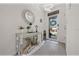 An elegant entryway features a decorative mirror, modern light fixture, and stylish console table with decor at 96 Hickory Crse, Ocala, FL 34472