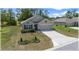 Beautiful single-story home with a well-manicured lawn and a long driveway at 96 Hickory Crse, Ocala, FL 34472