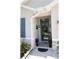 An inviting front porch with manicured landscaping and a welcoming entryway with decor at 96 Hickory Crse, Ocala, FL 34472