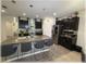 Spacious kitchen with dark cabinets, stainless steel appliances, a mosaic backsplash, and an island with seating at 96 Hickory Crse, Ocala, FL 34472