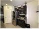 Modern kitchen with dark cabinets, stainless steel refrigerator and microwave, granite countertops, and ample storage at 96 Hickory Crse, Ocala, FL 34472