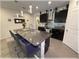 Bright kitchen with dark cabinets, a large island with seating, stainless steel appliances, and stylish pendant lighting at 96 Hickory Crse, Ocala, FL 34472