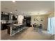 Open kitchen area with granite countertops, stainless steel appliances, an island with bar seating, and adjacent dining area at 96 Hickory Crse, Ocala, FL 34472