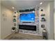 Stylish living room featuring a decorative stone wall with a fireplace and mounted TV at 96 Hickory Crse, Ocala, FL 34472