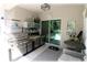Outdoor kitchen features stainless steel grill, sink, storage, and dining area at 96 Hickory Crse, Ocala, FL 34472