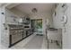 A well-equipped outdoor kitchen with stainless steel appliances and a dining area at 96 Hickory Crse, Ocala, FL 34472
