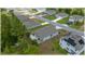 Aerial view showing the back of the house with a green lawn and neighborhood streets at 96 Hickory Crse, Ocala, FL 34472
