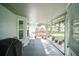Covered porch overlooks a large yard, featuring scattered trees, white rock accents, and a red deck at 10523 Sw 62Nd Terrace Rd, Ocala, FL 34476