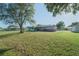 Expansive backyard with lush green grass, mature trees, and a deck, ideal for outdoor living at 10523 Sw 62Nd Terrace Rd, Ocala, FL 34476