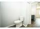 This half bathroom offers wood-look flooring, a toilet, and a modern vanity at 10523 Sw 62Nd Terrace Rd, Ocala, FL 34476