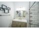Bathroom features a modern vanity, decorative accents, and tile in the shower at 10523 Sw 62Nd Terrace Rd, Ocala, FL 34476