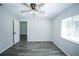 Bright bedroom features a ceiling fan, wood-look flooring, and lots of natural light from the window at 10523 Sw 62Nd Terrace Rd, Ocala, FL 34476
