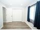 This bedroom features a closet, wood-look flooring, and natural light from a nearby window at 10523 Sw 62Nd Terrace Rd, Ocala, FL 34476
