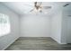 This bedroom offers wood-look flooring, natural light, and a ceiling fan with overhead lighting at 10523 Sw 62Nd Terrace Rd, Ocala, FL 34476