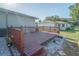 Red wooden deck with white rock surrounding it, with views of the backyard at 10523 Sw 62Nd Terrace Rd, Ocala, FL 34476
