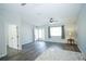 Bright living room with modern flooring, ceiling fan, and natural light at 10523 Sw 62Nd Terrace Rd, Ocala, FL 34476