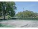 Outdoor tennis court with a well-maintained net and surface for recreational play at 10523 Sw 62Nd Terrace Rd, Ocala, FL 34476