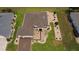 Aerial view of a well-maintained single Gathering home with beautiful landscaping, lawn, and a decorative driveway at 11871 Se 91St Cir, Summerfield, FL 34491