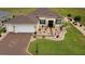 Aerial view of a charming single Gathering home with beautiful landscaping, spacious lawn, and a paved driveway at 11871 Se 91St Cir, Summerfield, FL 34491