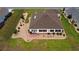 A bird's eye view of the home highlights the well-kept lawns, manicured garden beds, and sunny enclosed back patio at 11871 Se 91St Cir, Summerfield, FL 34491