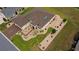 Aerial view of a charming single Gathering home featuring lush landscaping, lawn, and a paved driveway at 11871 Se 91St Cir, Summerfield, FL 34491