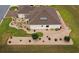Aerial view of house with well-manicured yard, rock beds, and detailed landscaping at 11871 Se 91St Cir, Summerfield, FL 34491