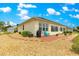 Exterior view featuring patio with seating and well-kept landscaping at 11871 Se 91St Cir, Summerfield, FL 34491