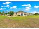 Exterior view of the back of the home featuring a spacious lawn at 11871 Se 91St Cir, Summerfield, FL 34491