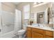 Bright bathroom with a shower/tub combination and wooden vanity at 11871 Se 91St Cir, Summerfield, FL 34491