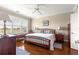 Cozy bedroom features hardwood floors, natural light and a ceiling fan at 11871 Se 91St Cir, Summerfield, FL 34491