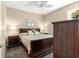 Comfortable bedroom with ceiling fan, plush bedding, and carpet flooring at 11871 Se 91St Cir, Summerfield, FL 34491