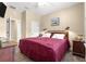 Comfortable bedroom with neutral walls, plush bedding, and bedside lamps at 11871 Se 91St Cir, Summerfield, FL 34491